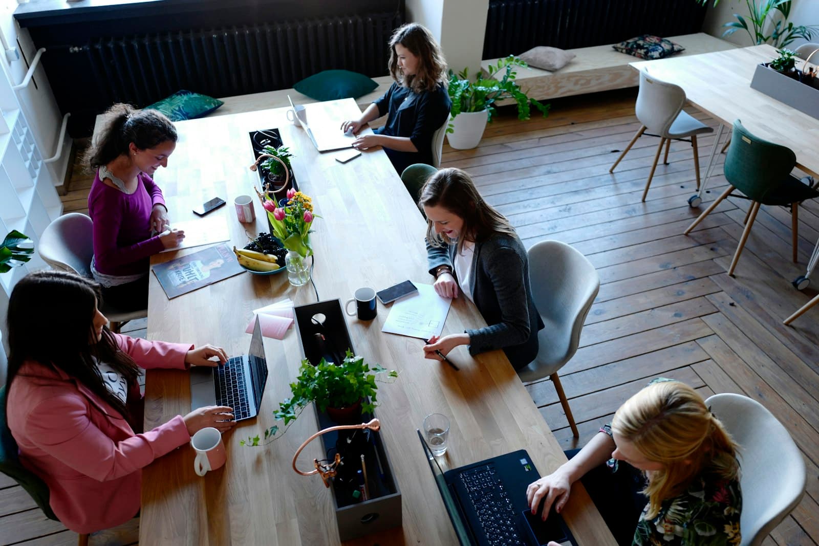 Agency team working around a long table in a bright studio