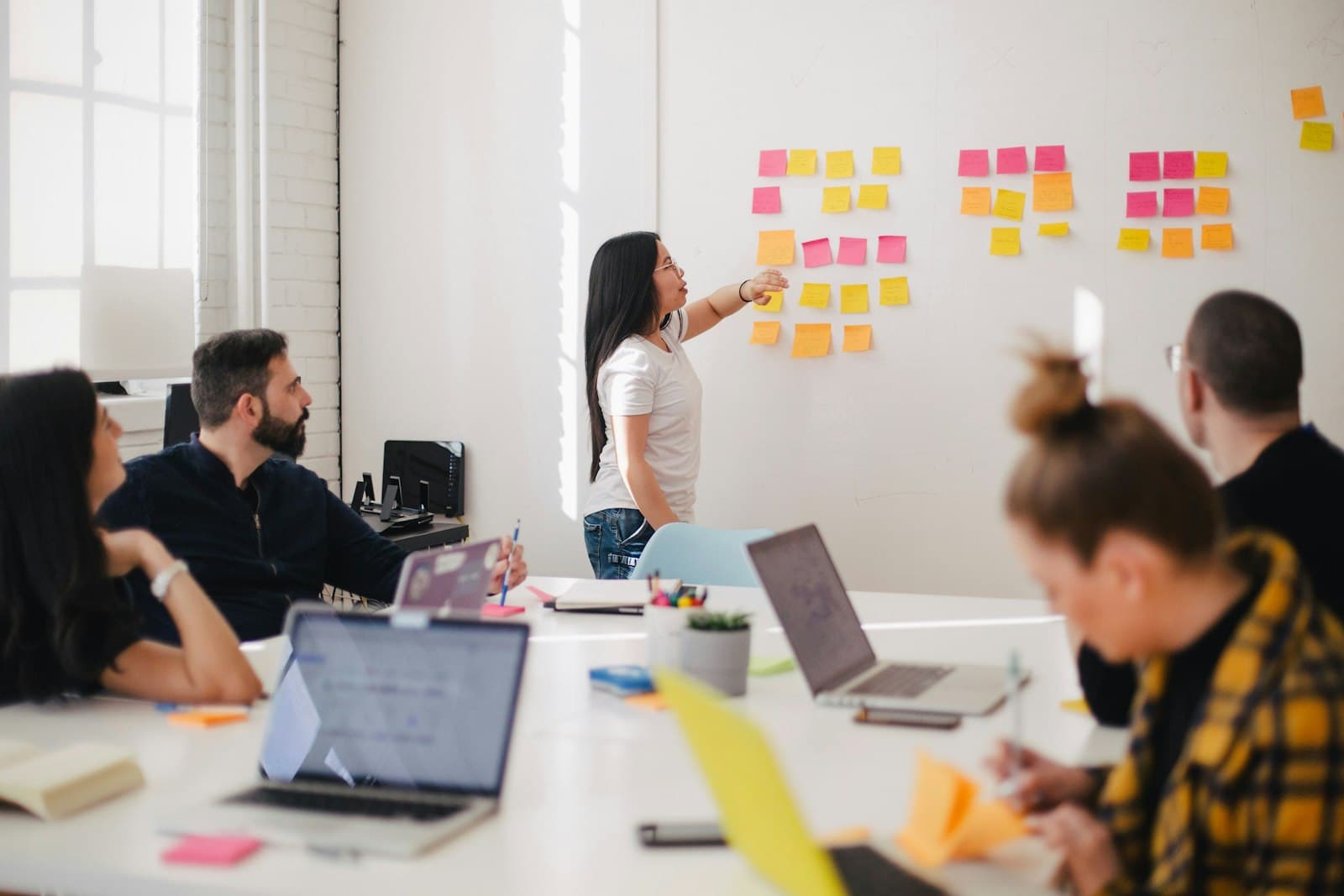 Marketing team reviewing a campaign board of sticky notes