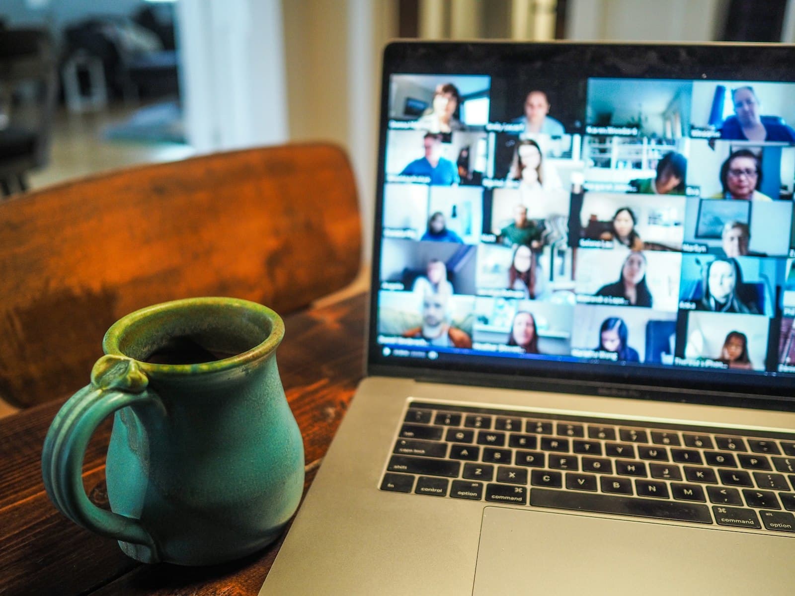 Laptop showing a video call with a grid of participants